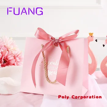 Цена по прейскуранту завода-изготовителя Розовый упаковочный бумажный пакет с логотипом на заказ с ручкой и лентой, подарочная сумка для покупок